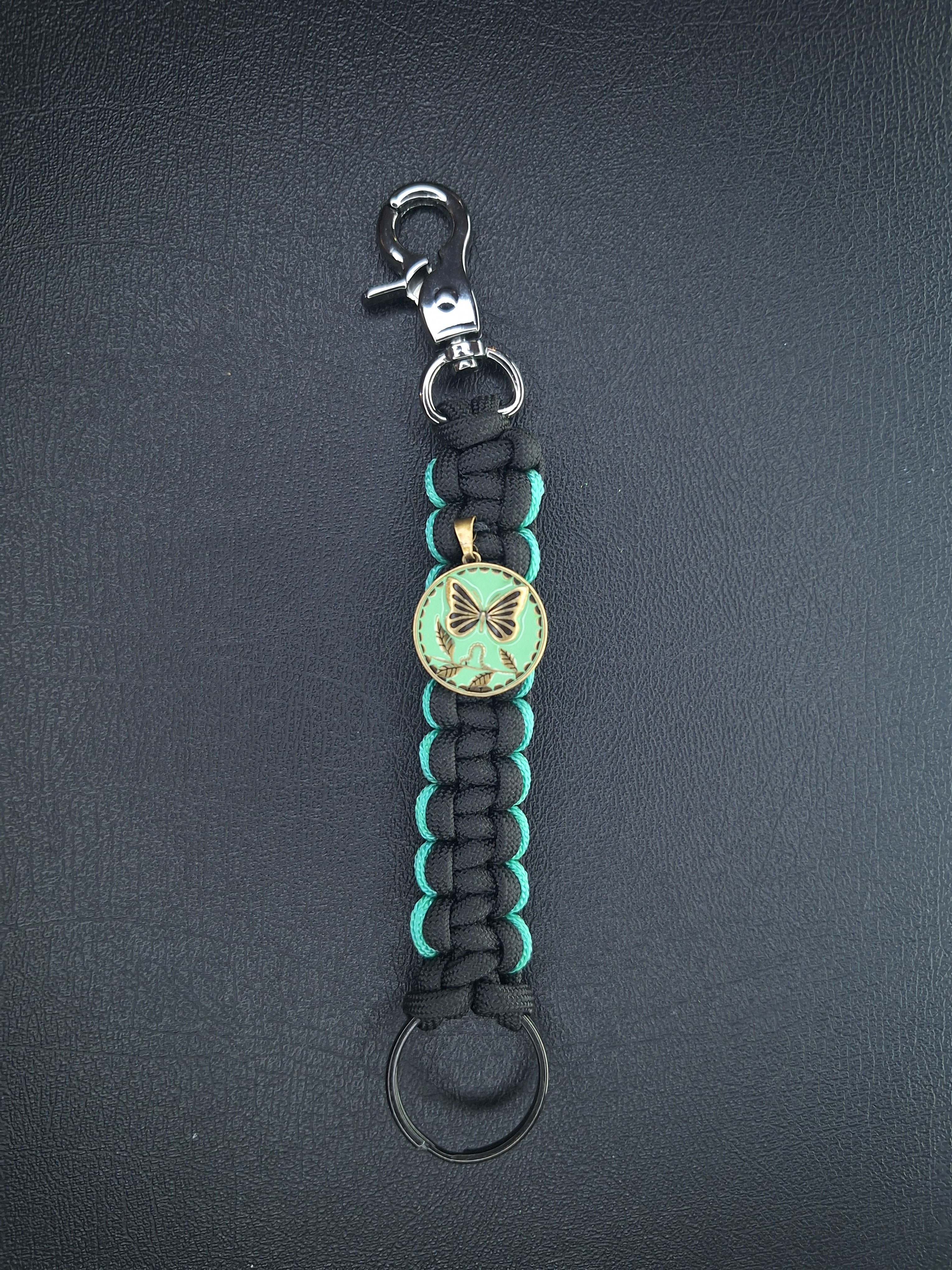 black w/teal paracord keychain with butterfly pendant