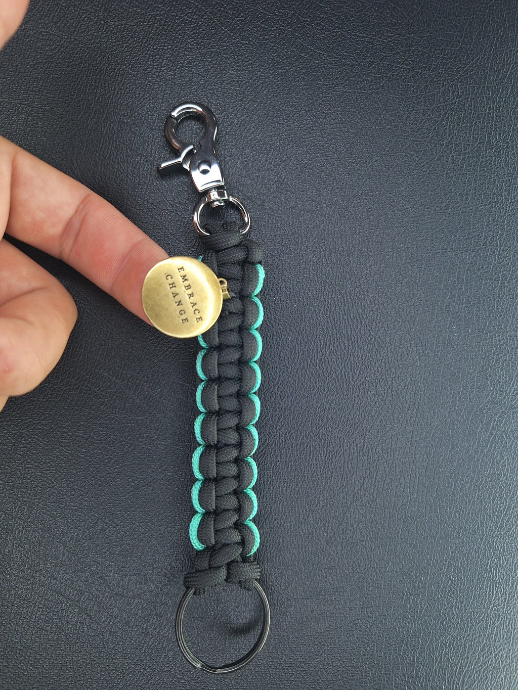 black w/teal paracord keychain with butterfly pendant