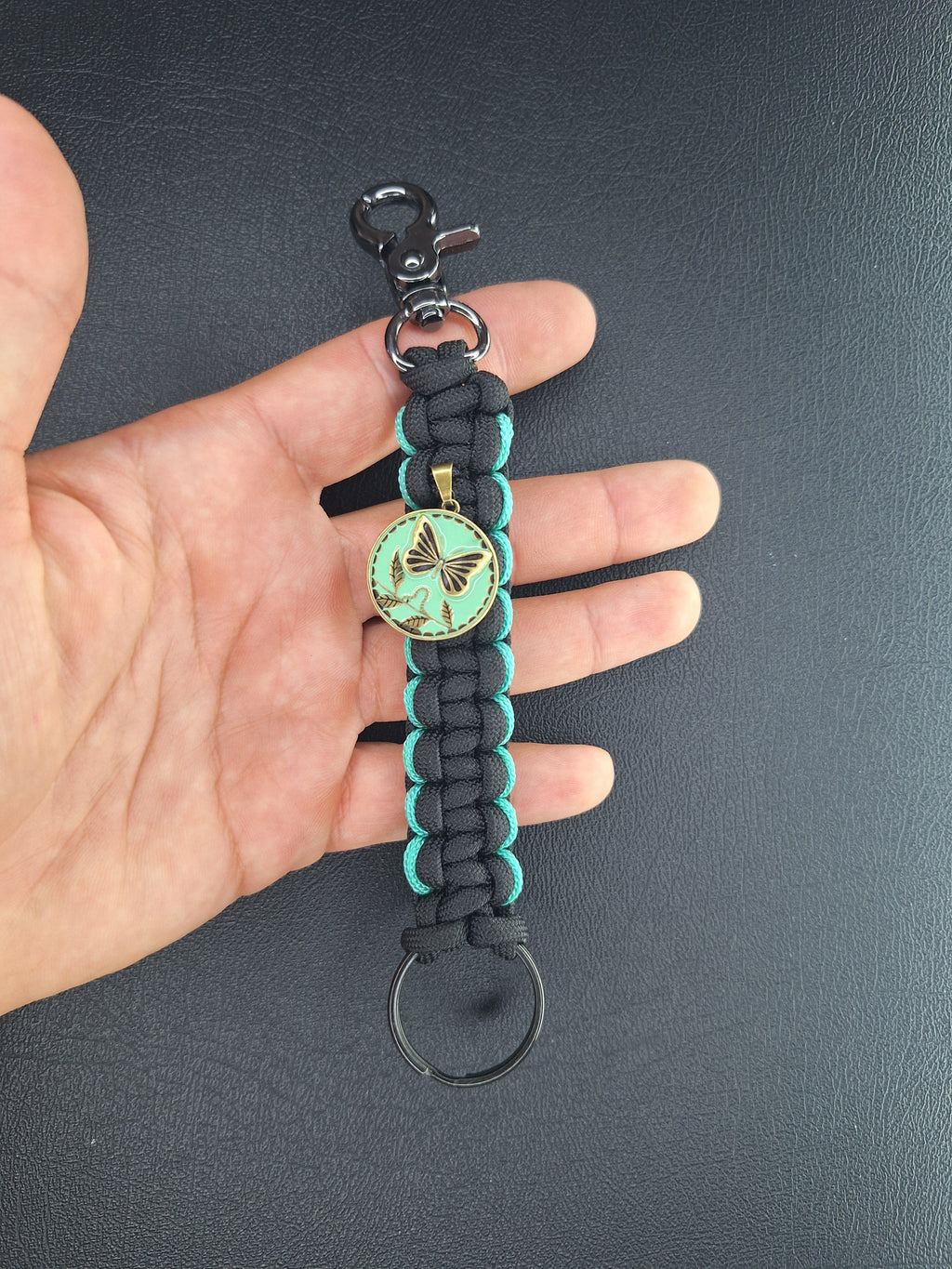 black w/teal paracord keychain with butterfly pendant