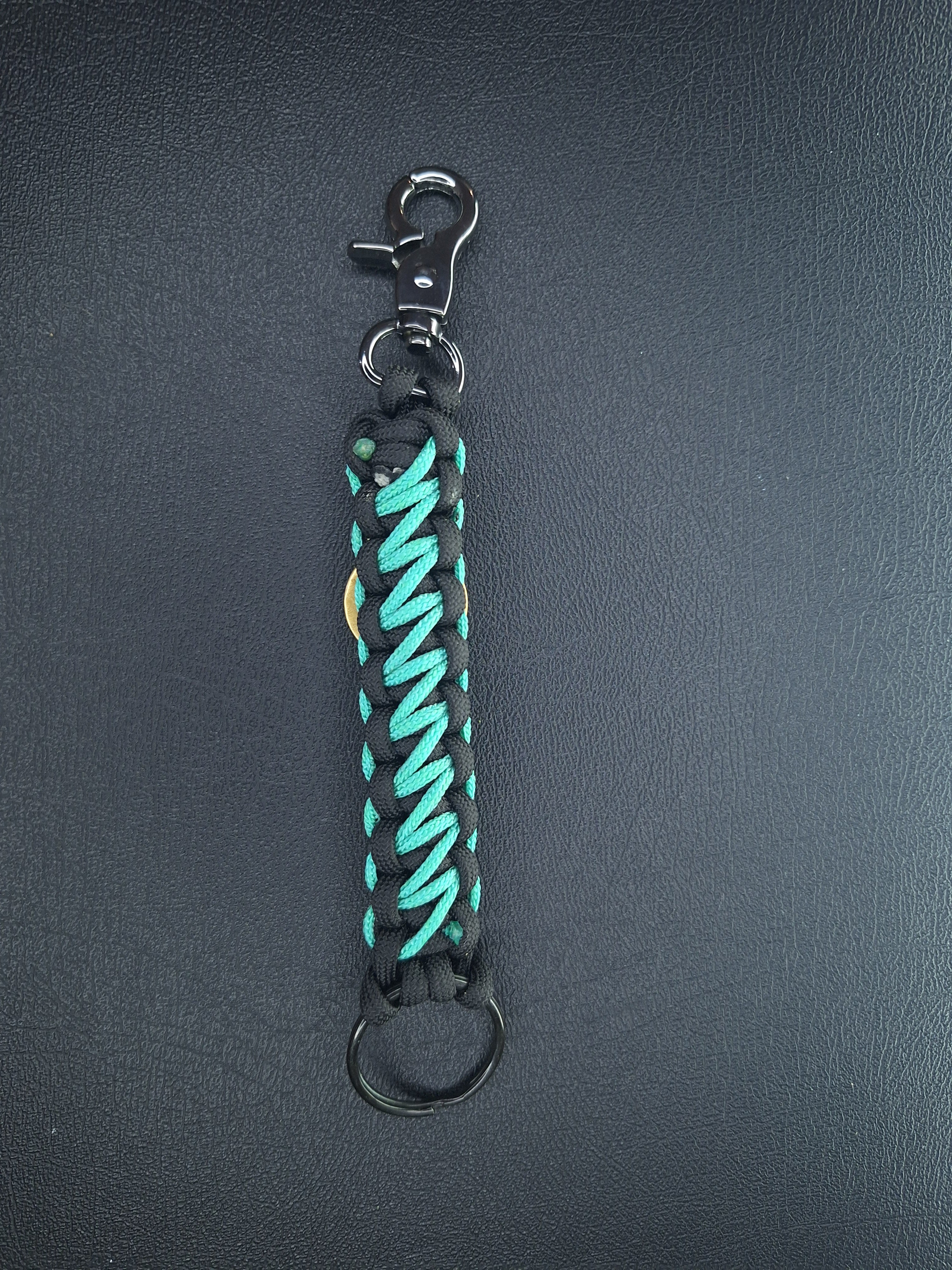 black w/teal paracord keychain with butterfly pendant